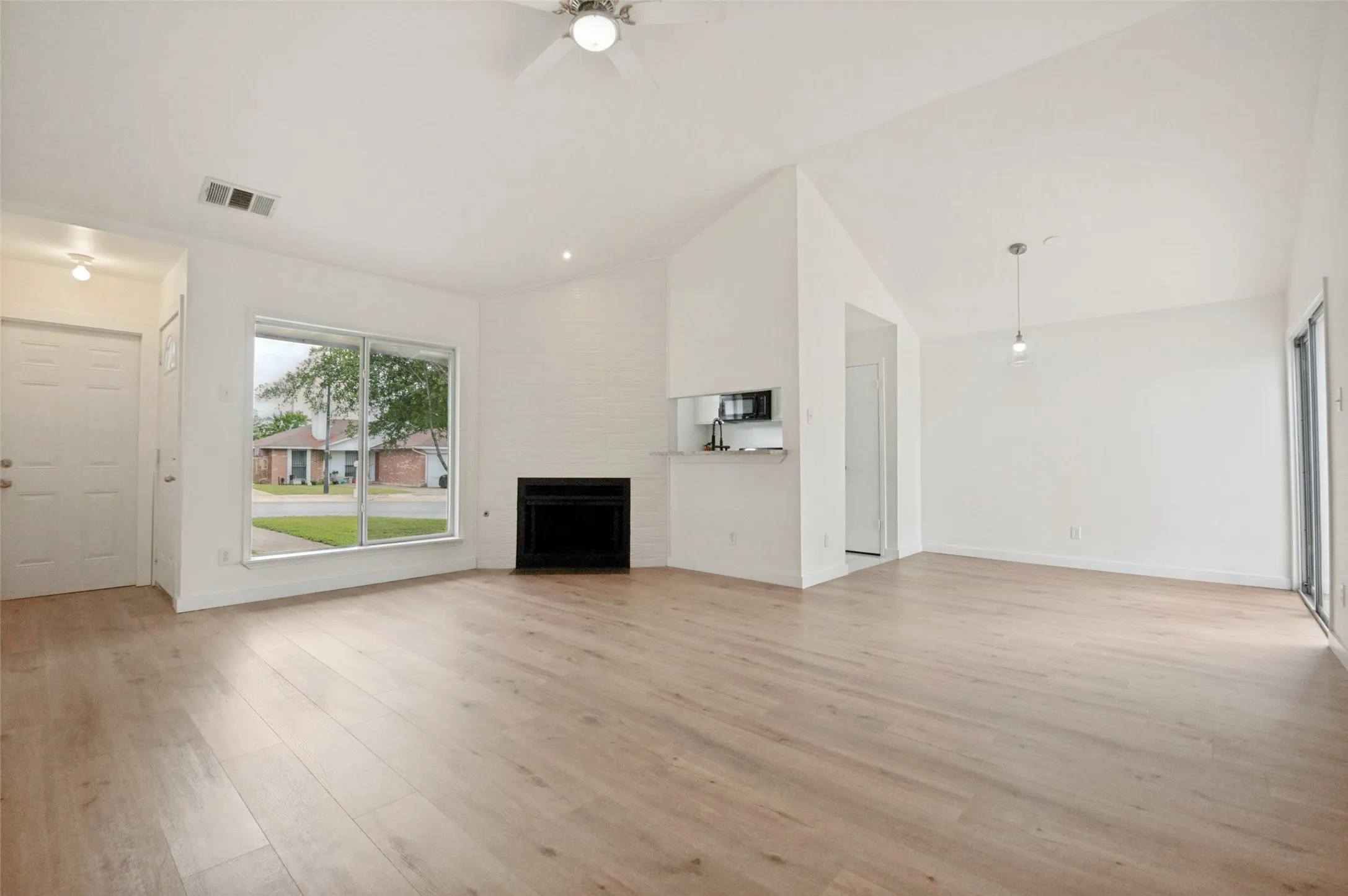 Living room features a tiled fireplace.