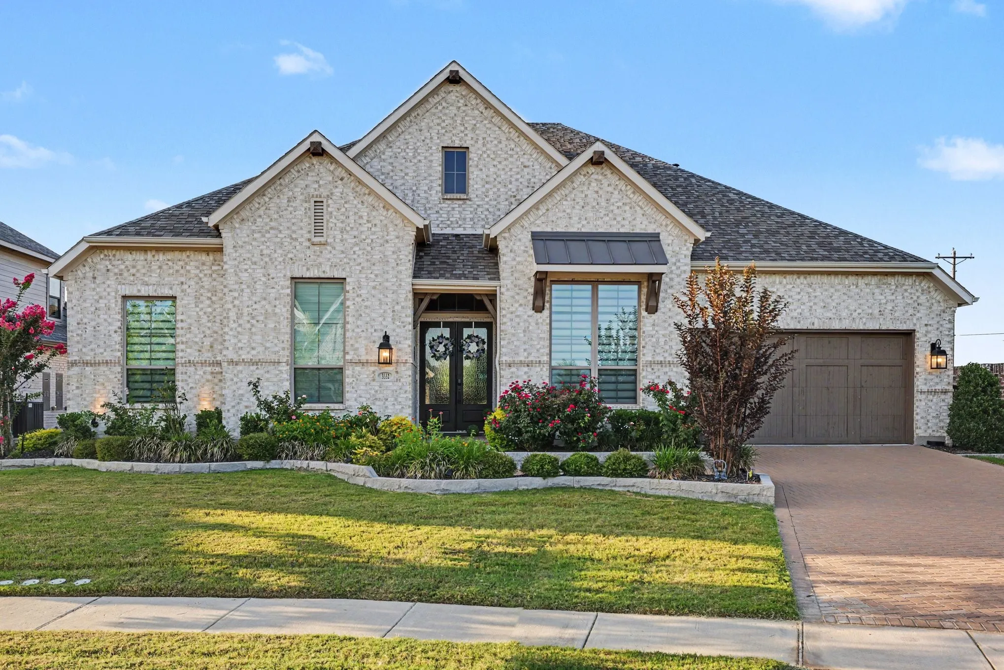 Brick exterior with dark shingle roofing
