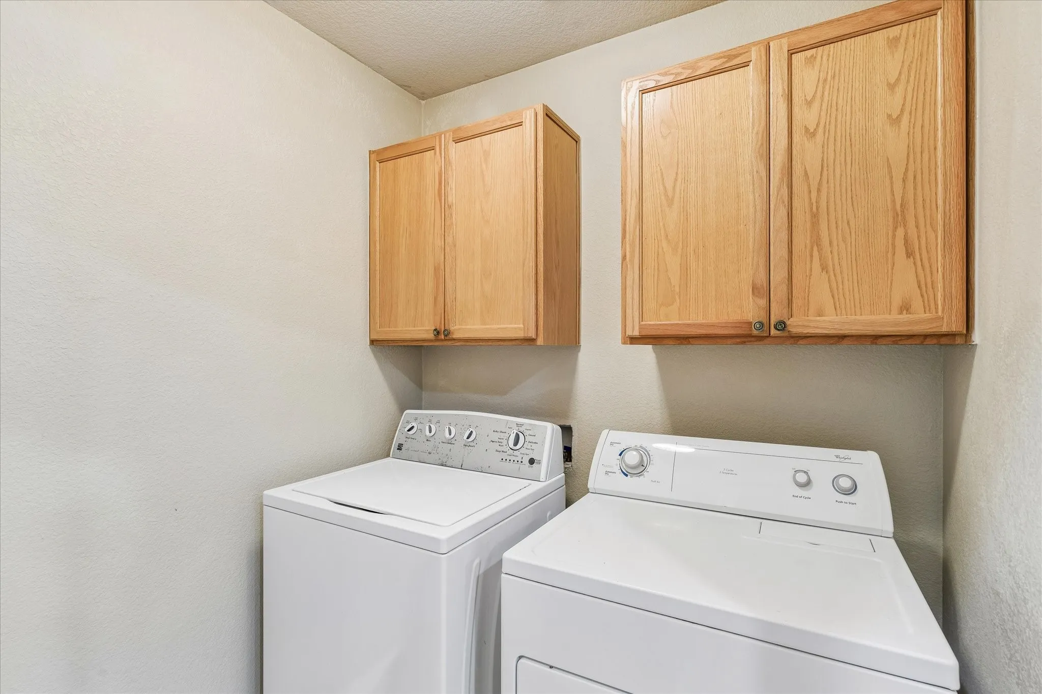 Utility room off the kitchen with more cabinets!