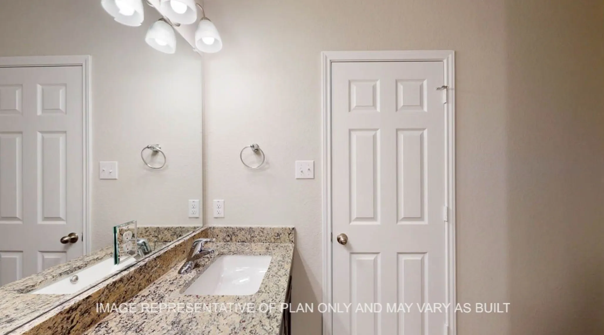 Bathroom vanity with a white rectangular undermount sink, a chrome-finish faucet, and a polished stone countertop