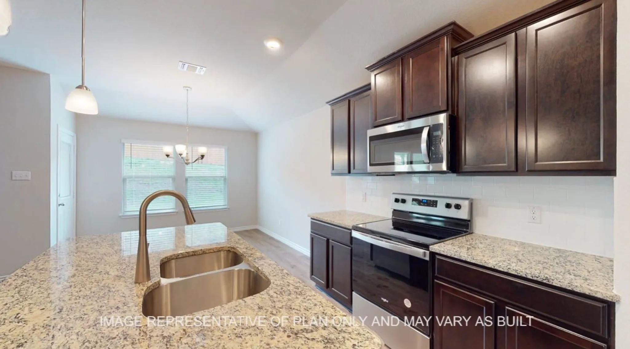 Kitchen featuring dark wood-finish cabinetry, stainless steel appliances, granite countertops, and a subway tile backsplash
