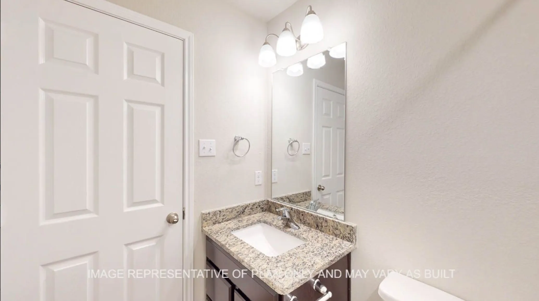 Vanity with granite countertop, integrated sink, and dark wood-finish cabinetry