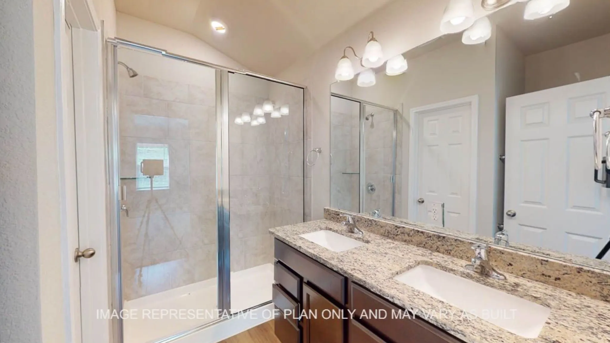 Dual vanity with light-toned countertop, dark wood-finish cabinetry, and undermount sinks