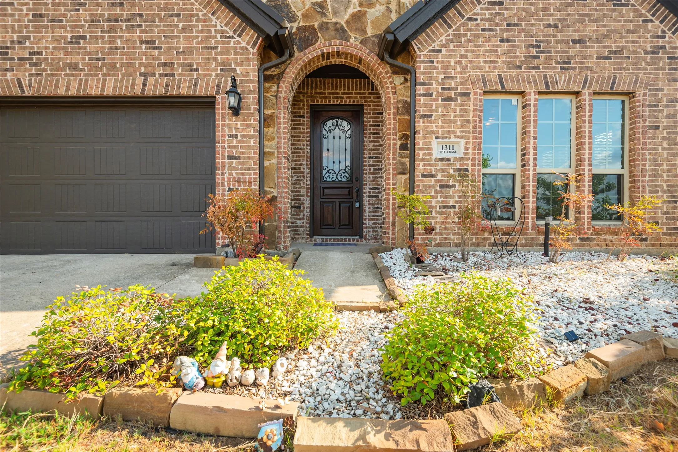 Brick and stone facade with an arched entry