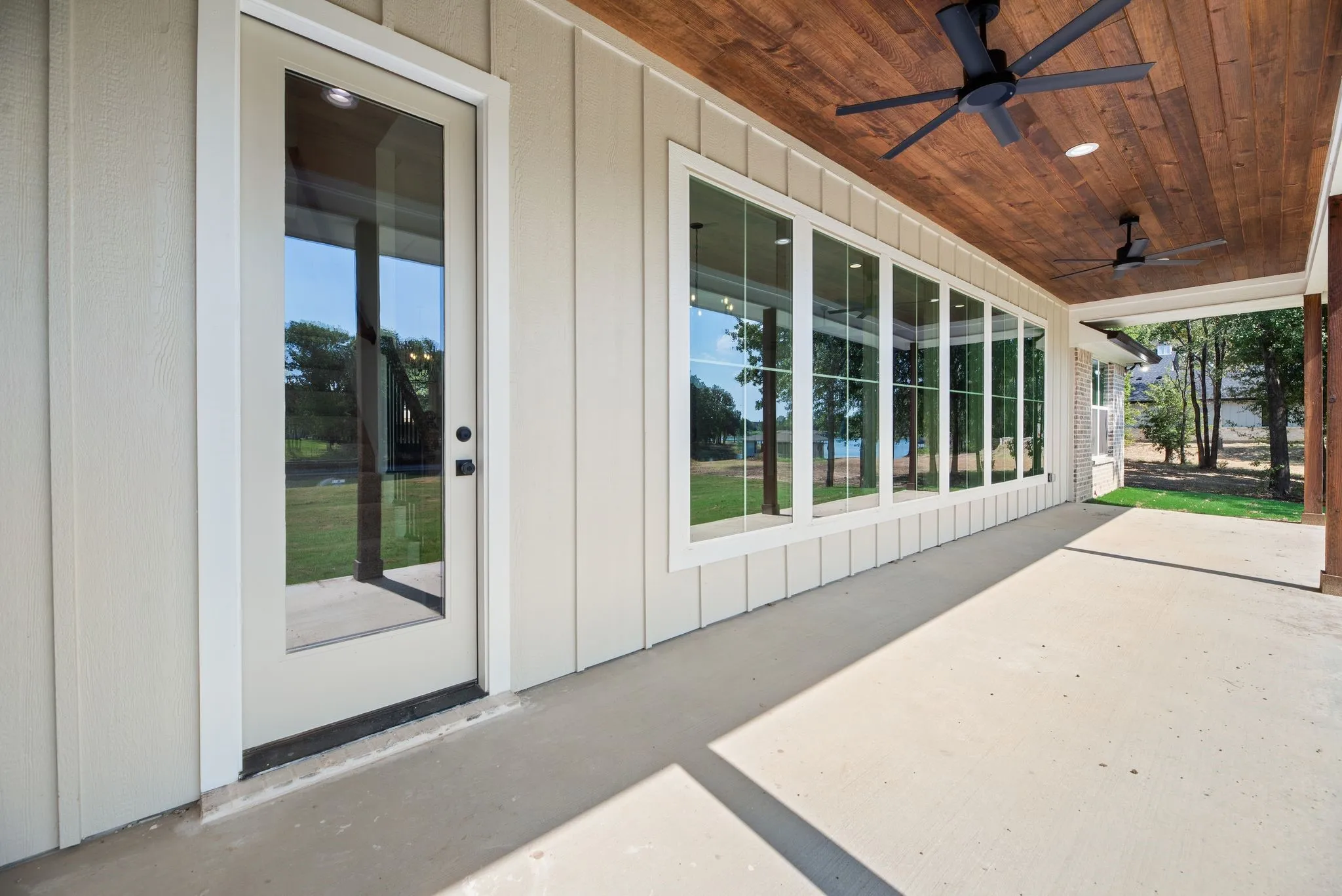 Covered rear porch extends the living space outdoors with ceiling fans and plenty of room to relax near the Richland Chambers Lake waterfront.