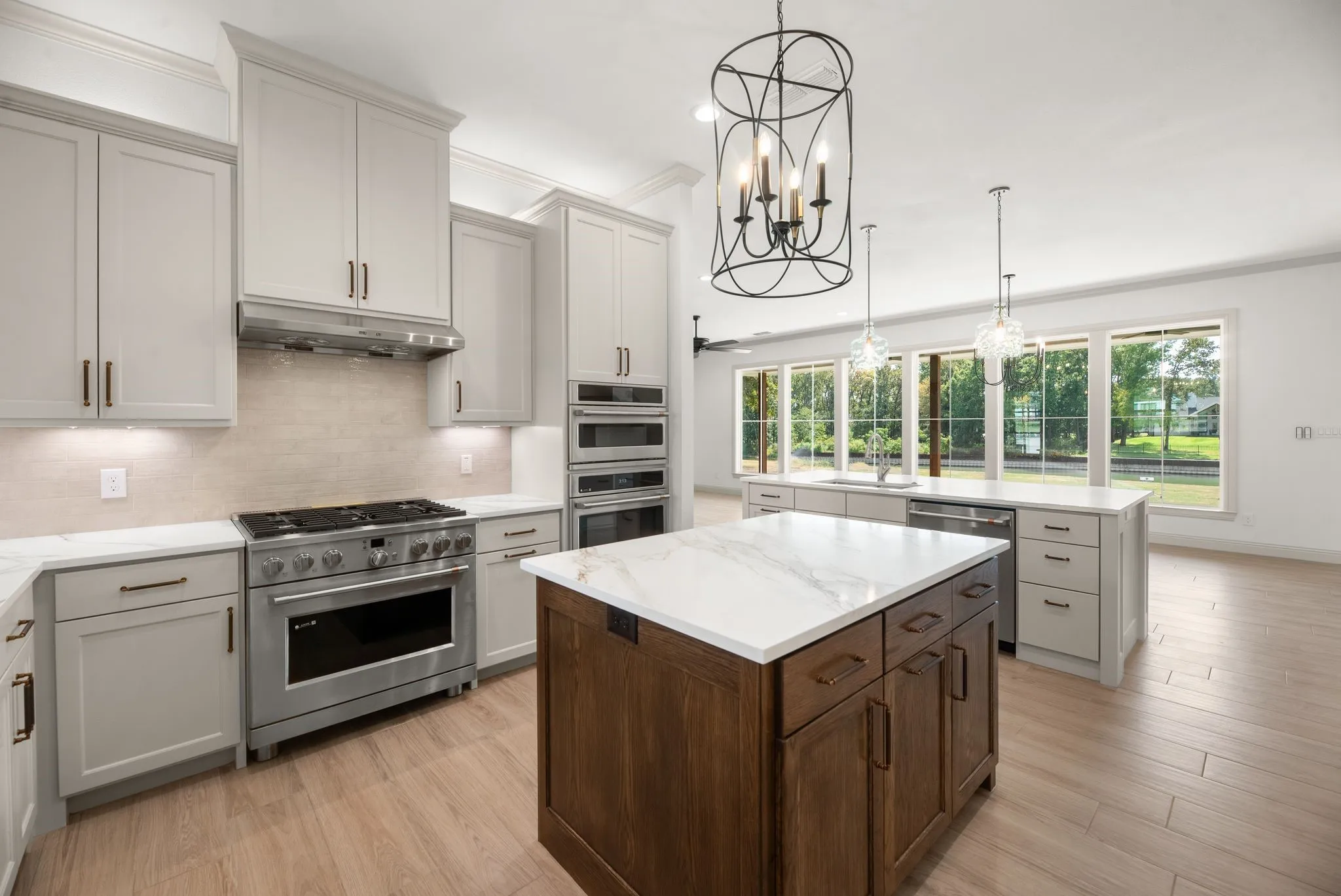 Chef-inspired kitchen offers a built-in gas range, abundant cabinetry, generous work surfaces, and custom finishes for everyday entertaining.