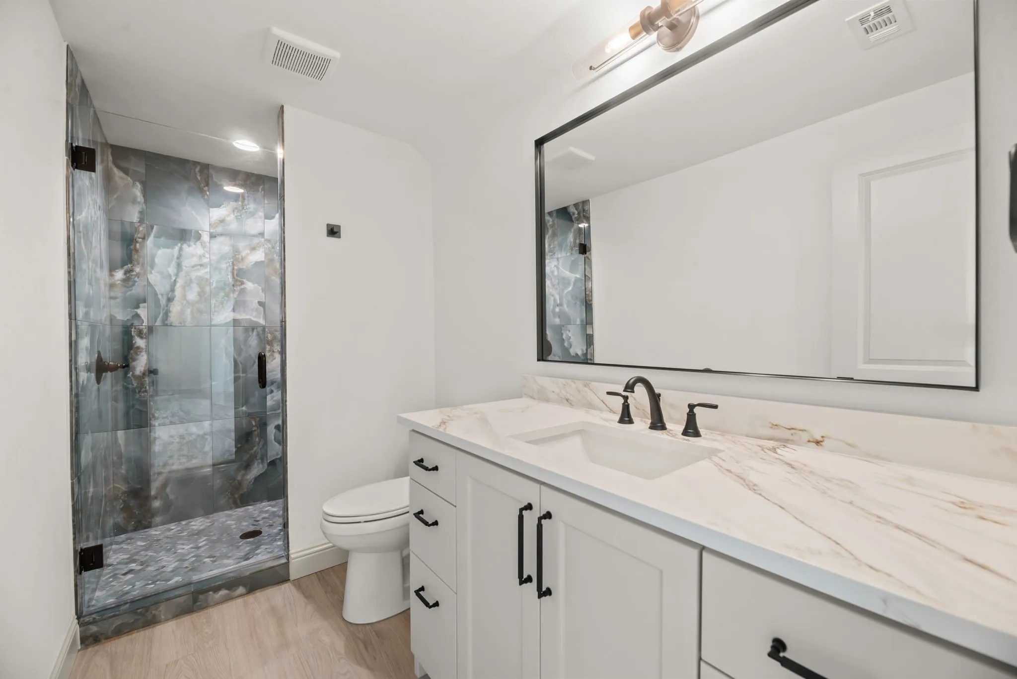 Upstairs full bathroom makes the spacious bonus room even more versatile for guests, entertaining, or a future bunkroom setup.