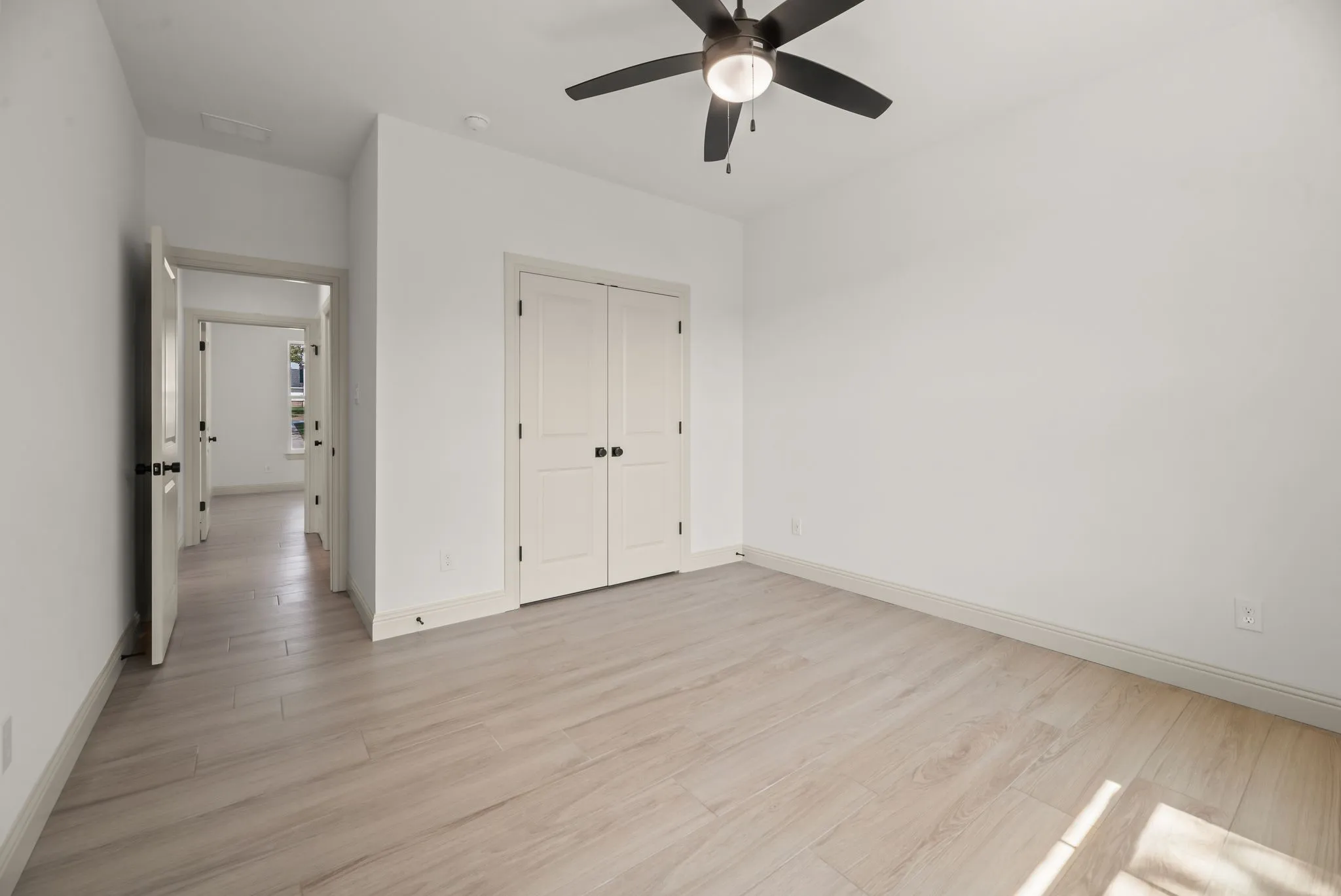 Comfortable guest bedroom provides natural light, a ceiling fan, and flexible space for family and visitors at Richland Chambers Lake.