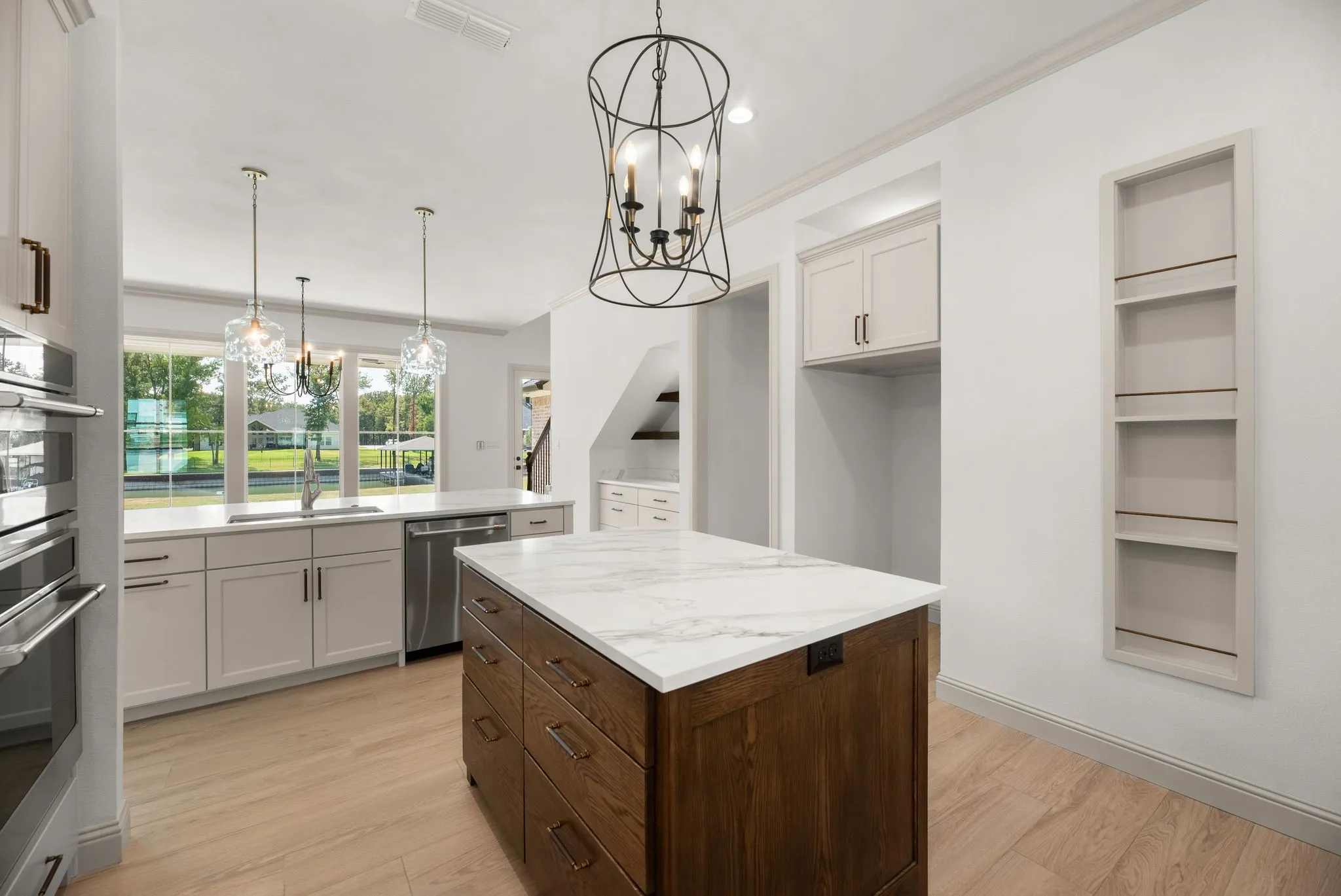 Dedicated prep island adds valuable workspace to the custom kitchen while nearby storage keeps this Richland Chambers Lake home organized.