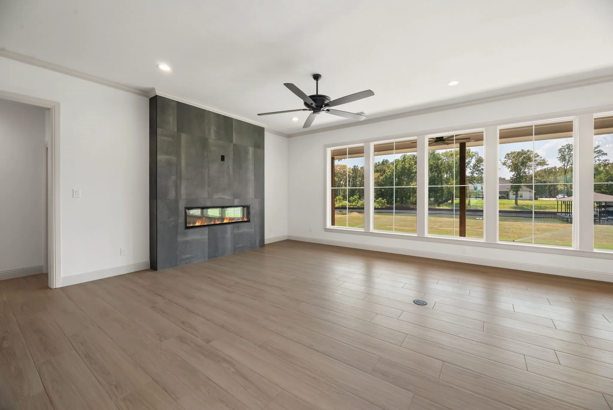 Expansive windows fill the living room with natural light while framing the beautiful waterfront surroundings of this Richland Chambers Lake home.