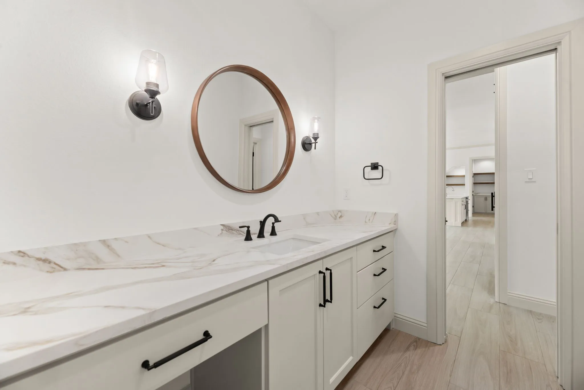 Well-appointed secondary bathroom features a stylish vanity, contemporary fixtures, and clean neutral finishes.