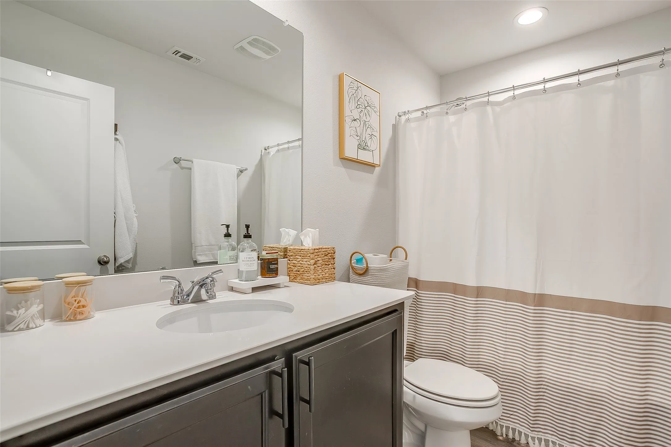Vanity with an integrated sink, polished chrome faucet, and dark wood-finish cabinetry