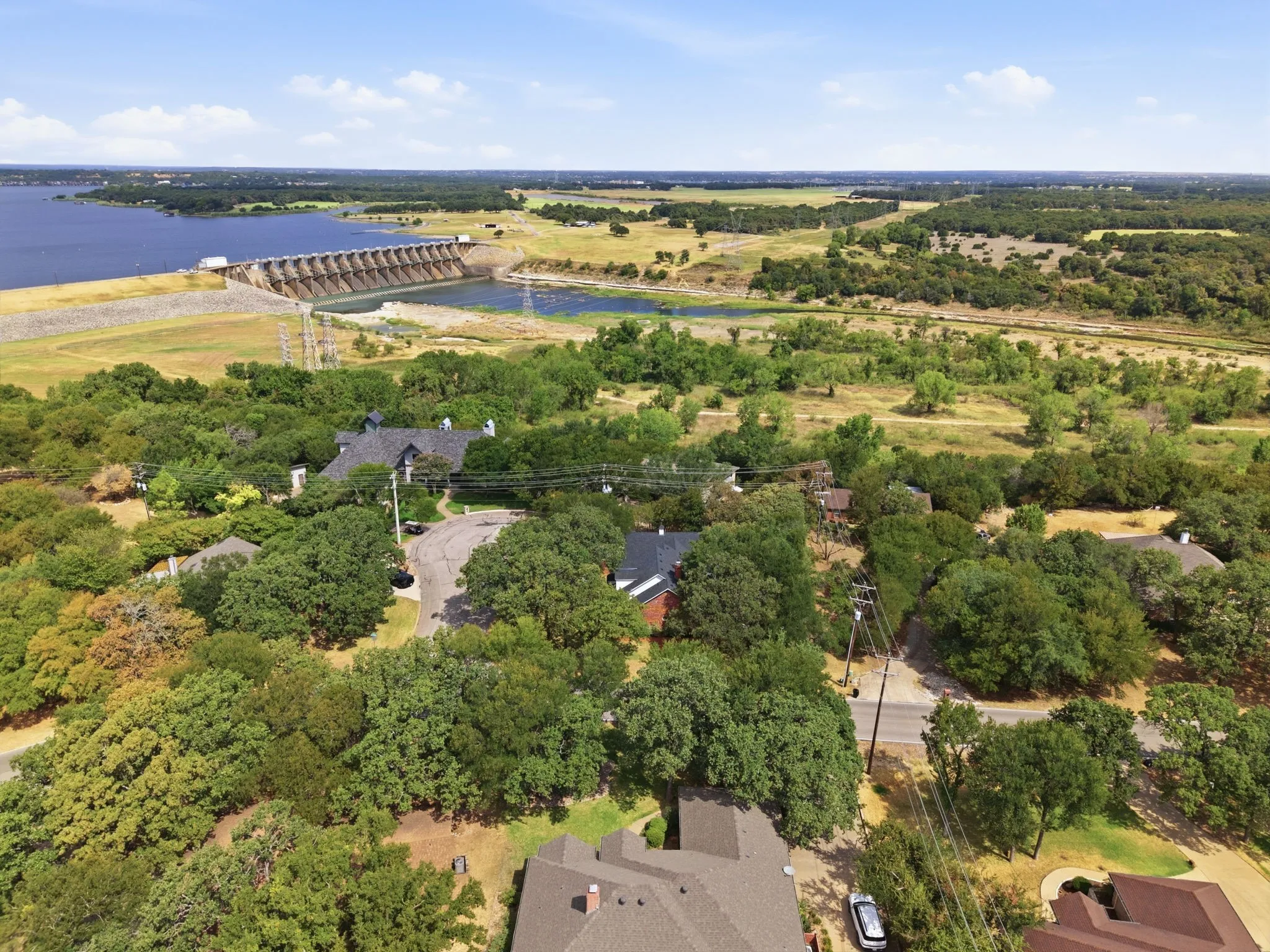 Expansive natural landscape with a large body of water and a prominent dam structure