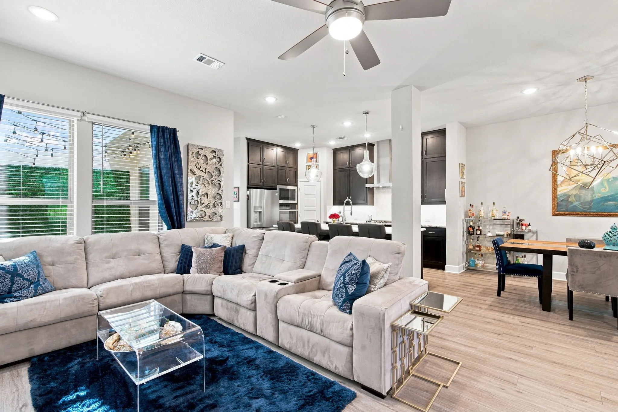 Wood-finish flooring throughout, ceiling fan with integrated lighting, and recessed ceiling lights