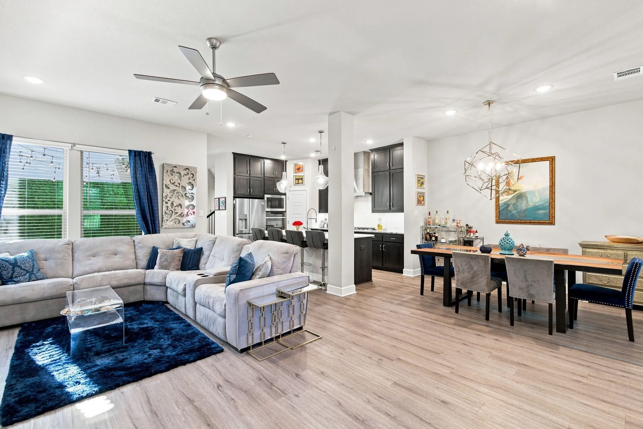 Open concept living area featuring wood-finish flooring, recessed lighting, and a contemporary ceiling fan