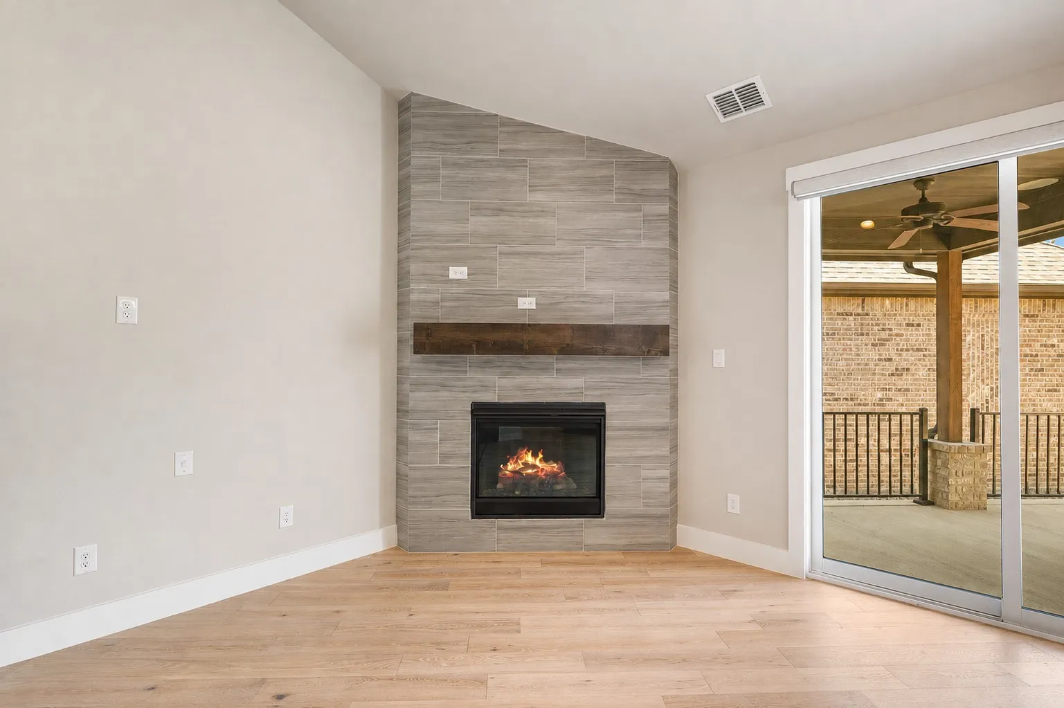 Floor to ceiling gas fireplace is a focal point in the living room.