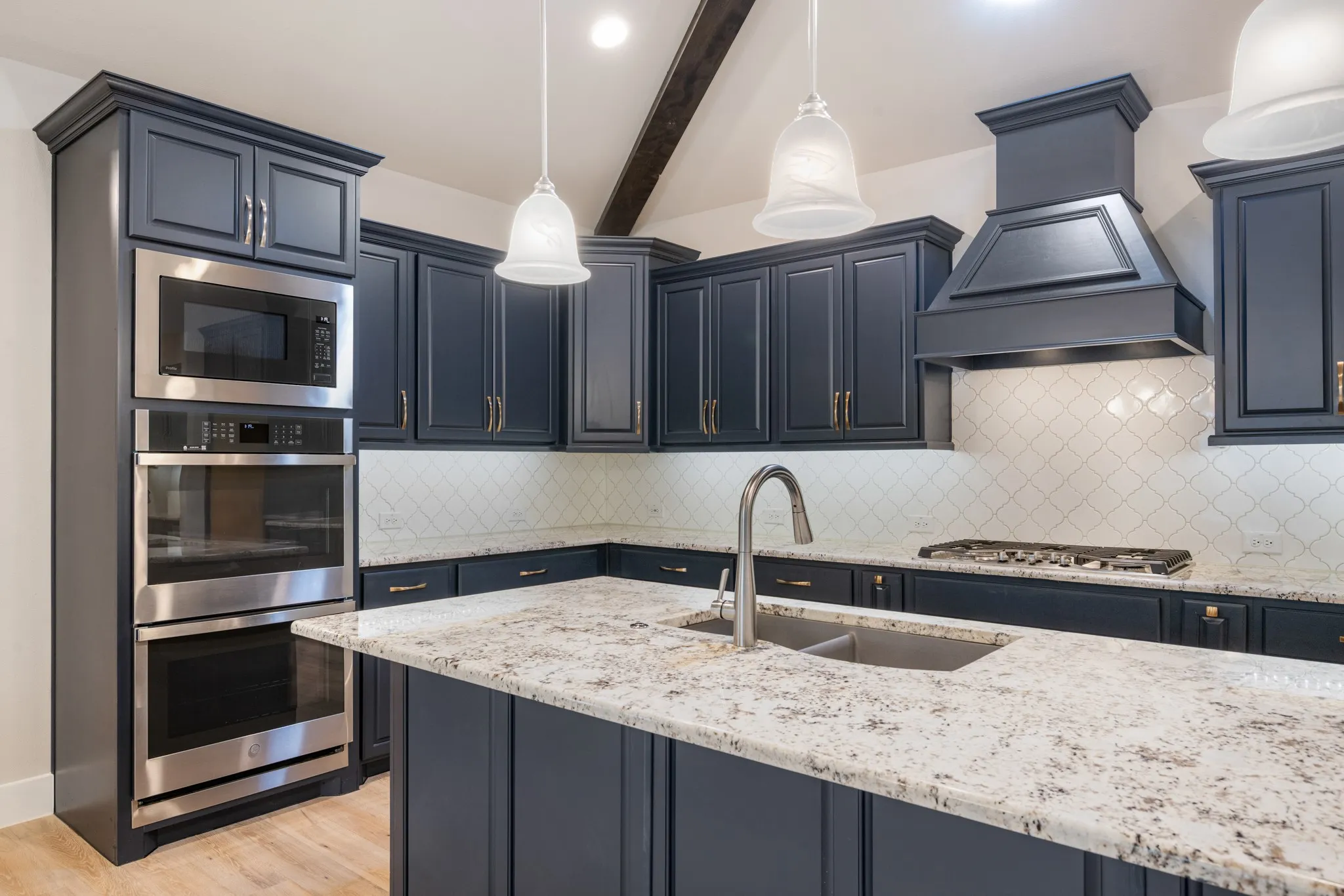 Kitchen features double ovens and a built in microwave.