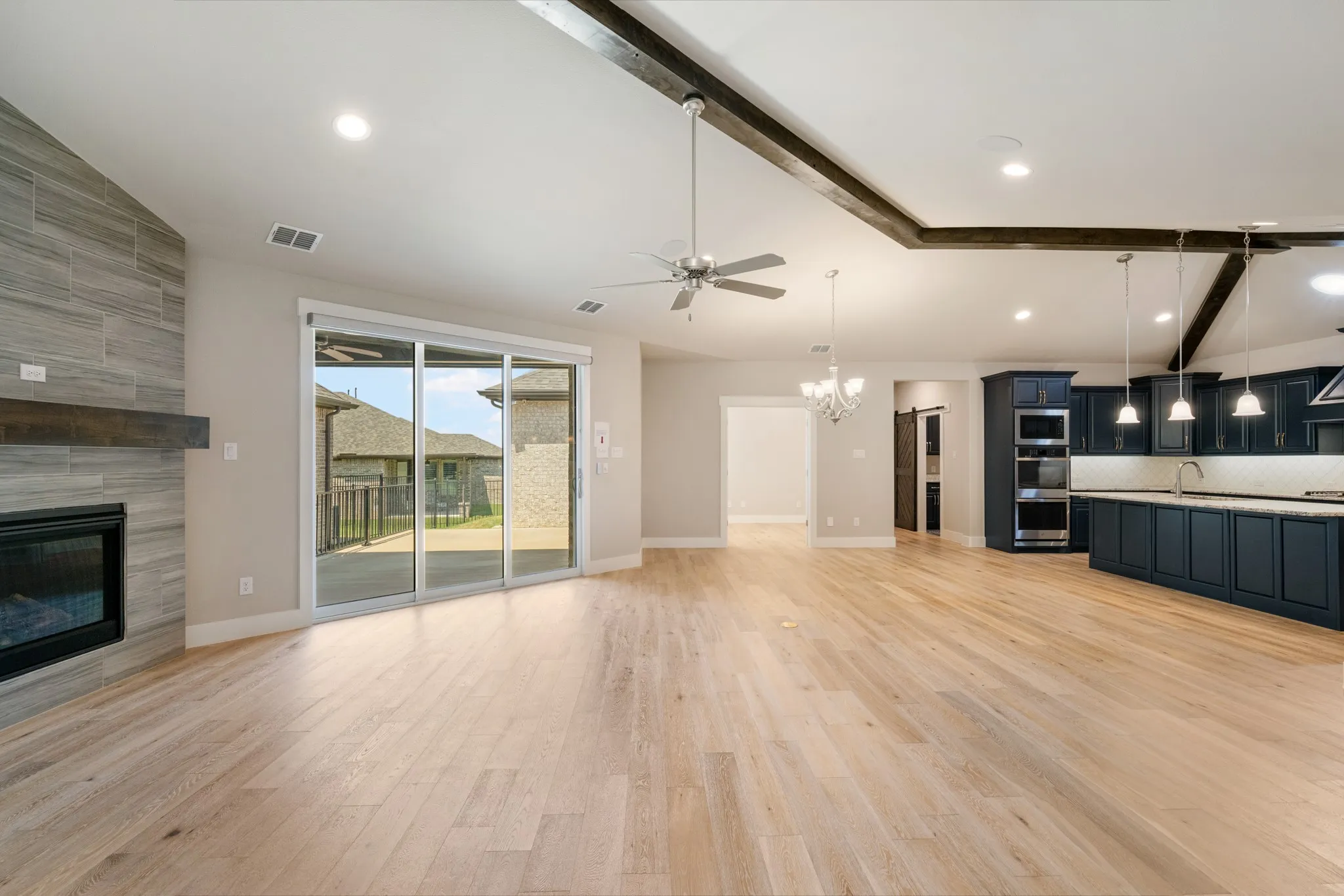 Light and bright living room with view of covered patio.