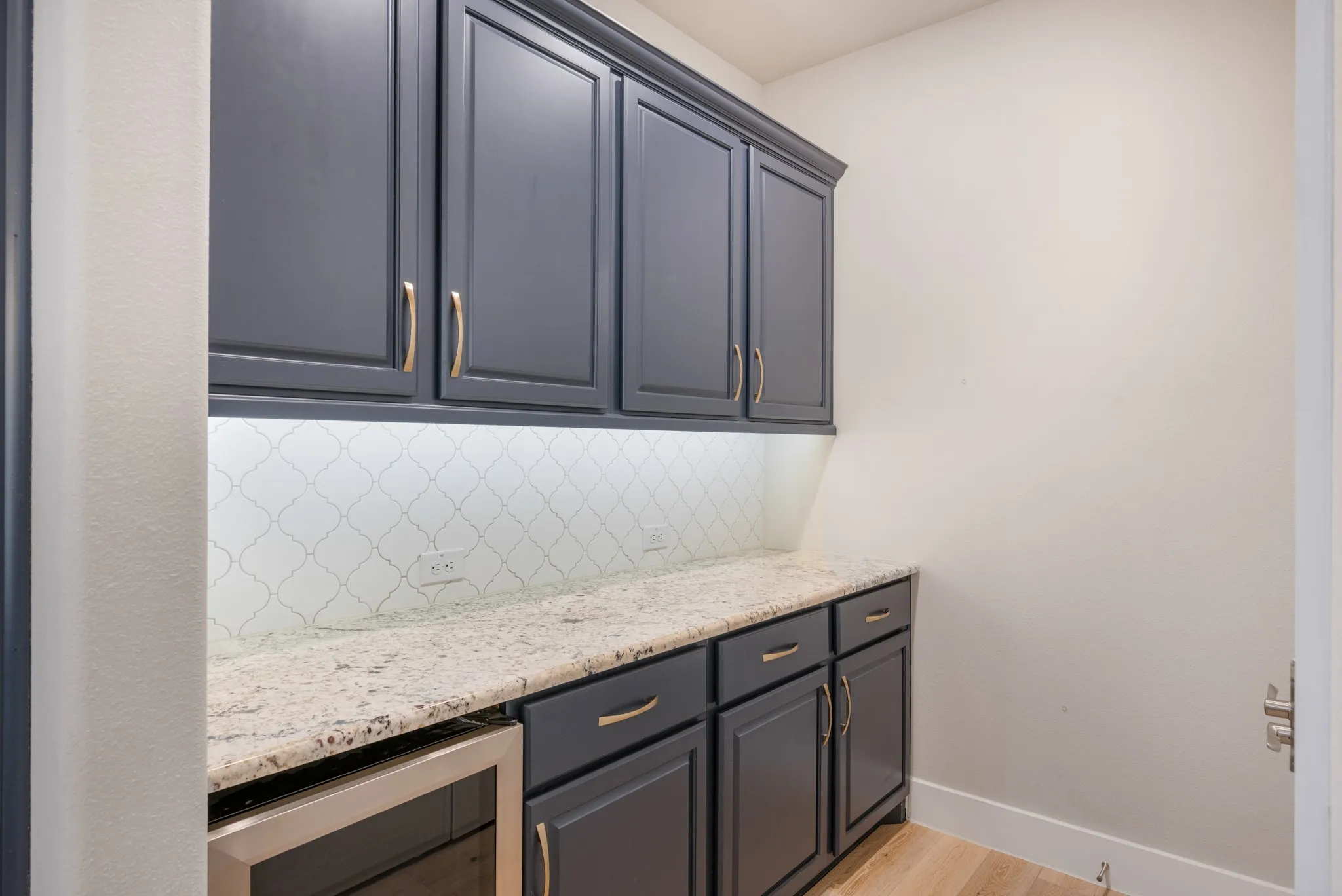 Built in storage and wine fridge in butler's pantry.