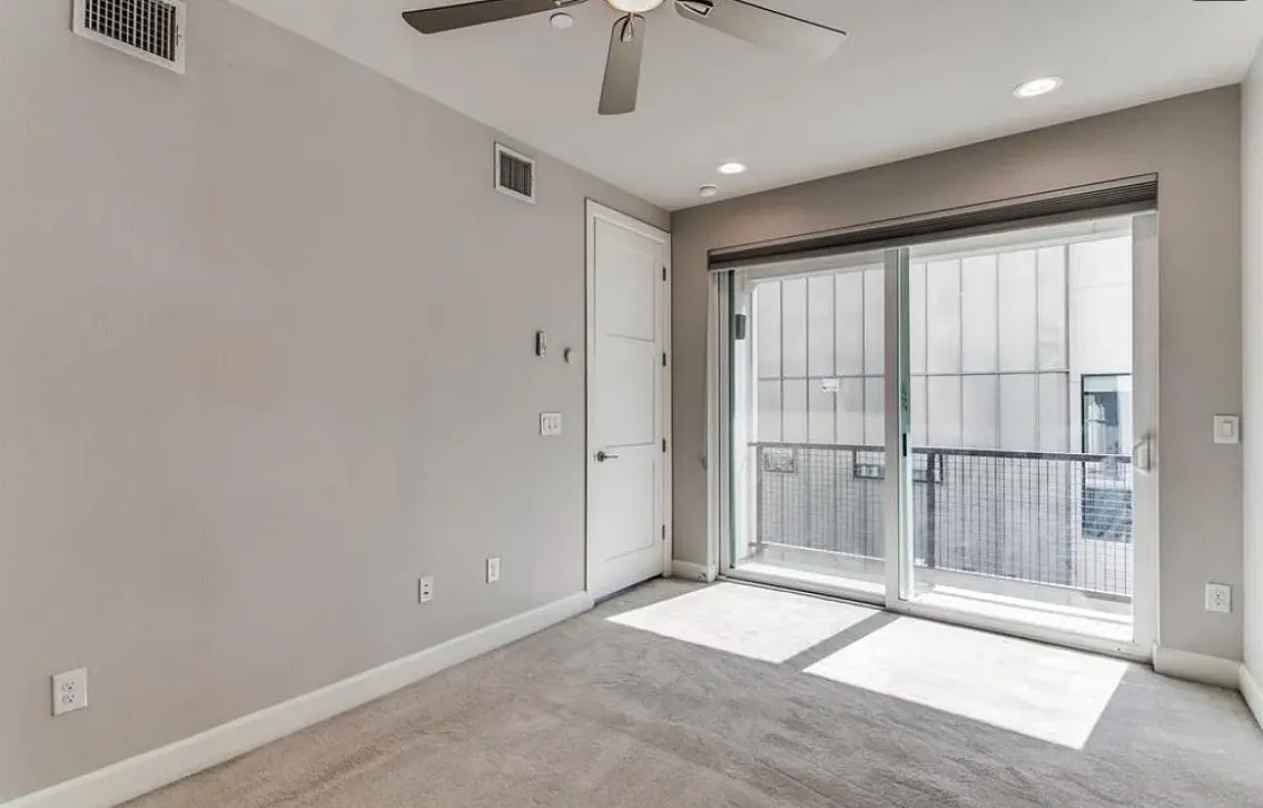 Sliding glass doors with balcony access, recessed lighting, ceiling fan, neutral wall tones, and light-toned carpeting