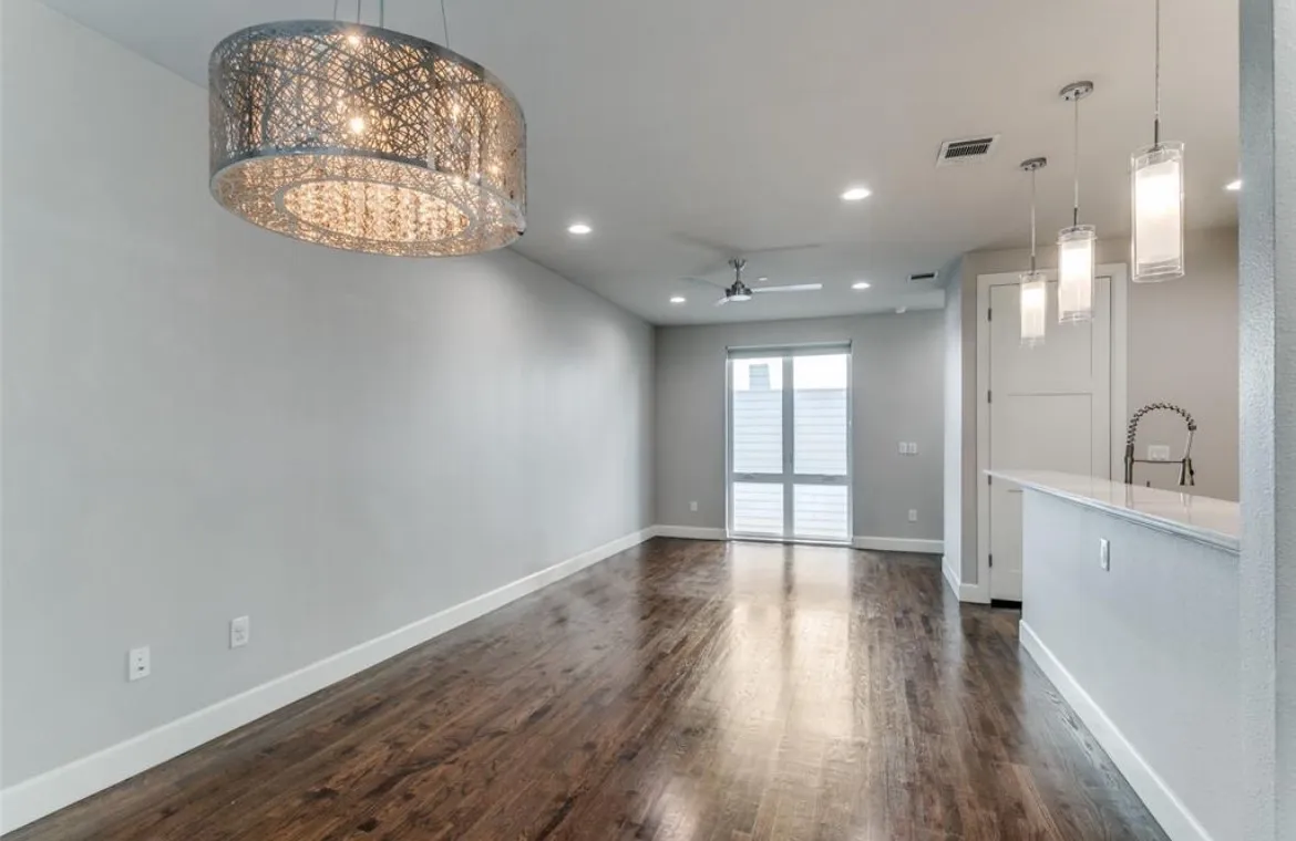 Hardwood-style flooring, contemporary chandelier, recessed lighting, ceiling fan, and sliding glass door