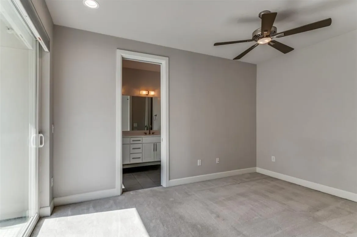 Recessed ceiling lighting, ceiling fan with integrated light, carpeted flooring, and glass sliding door