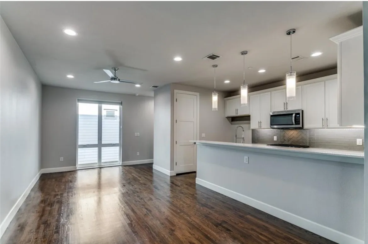 Open-concept living space featuring wood-finish flooring, recessed lighting, and a ceiling fan