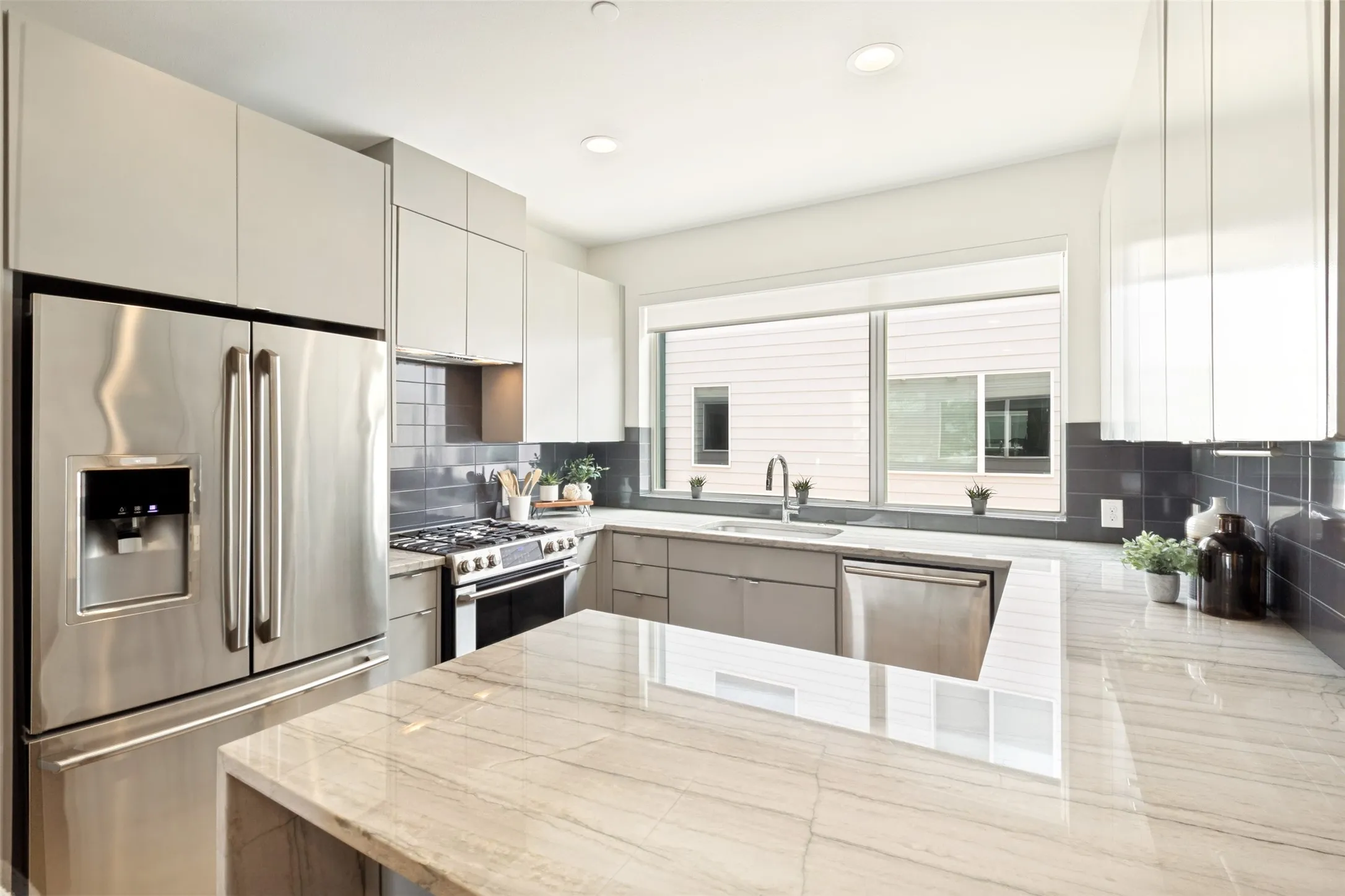 Quartz countertops, stainless steel appliances(refrigerator included), gas range. Clean and modern. Breakfast bar for stools.