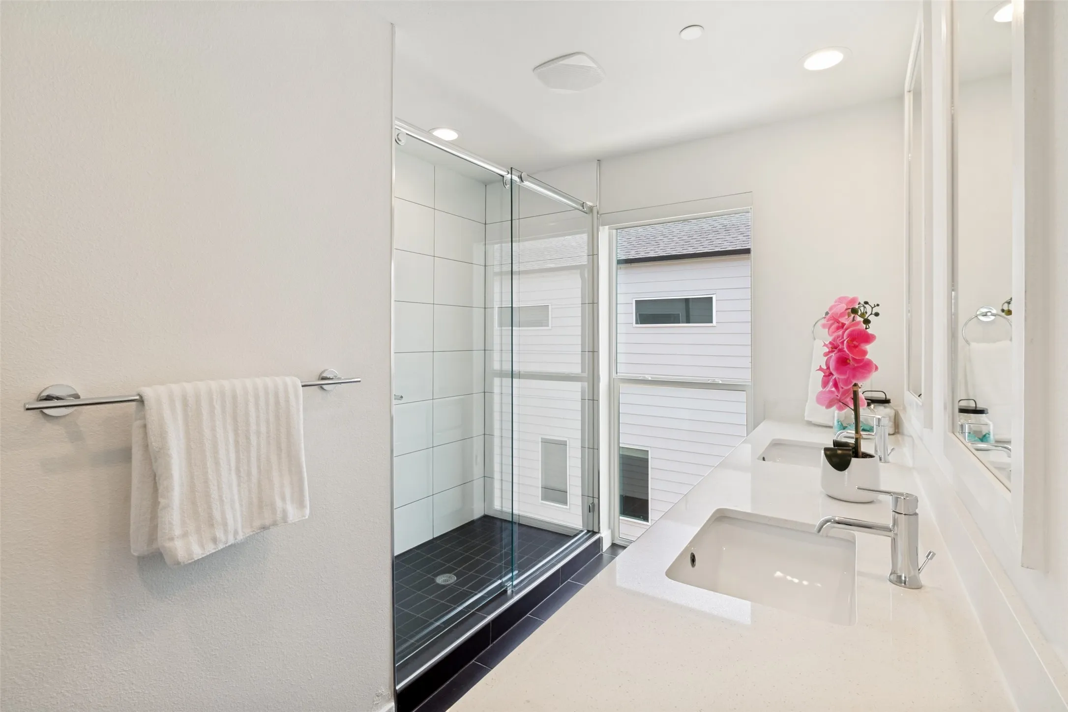Sleek primary bath. Large walk in shower, Dual sinks