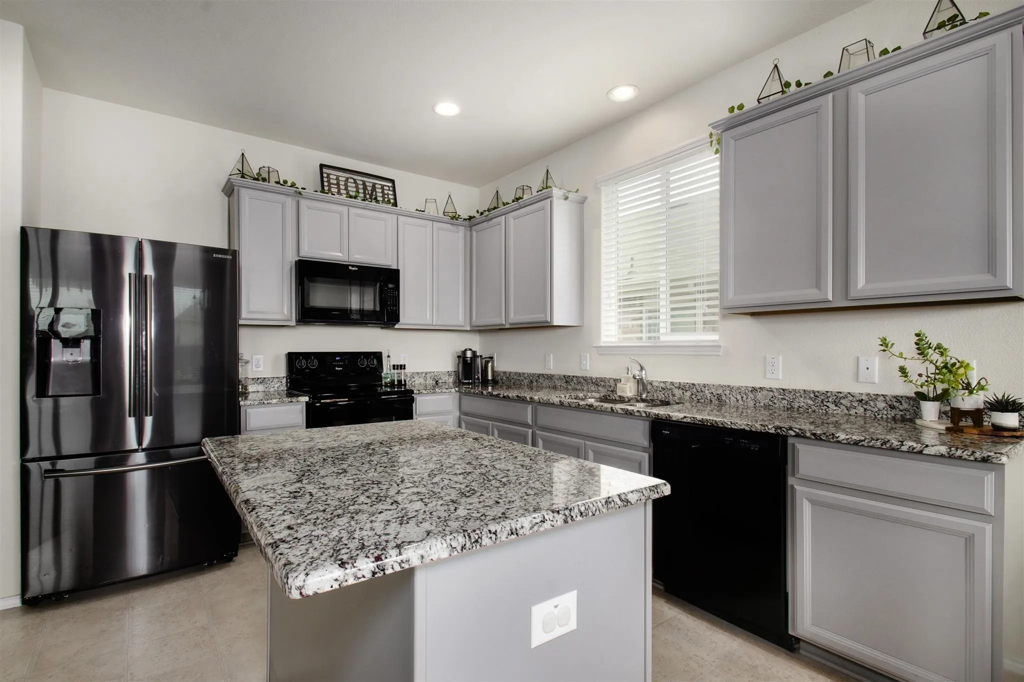 Kitchen with light gray cabinetry, dark stainless steel appliances, granite countertops, and recessed lighting