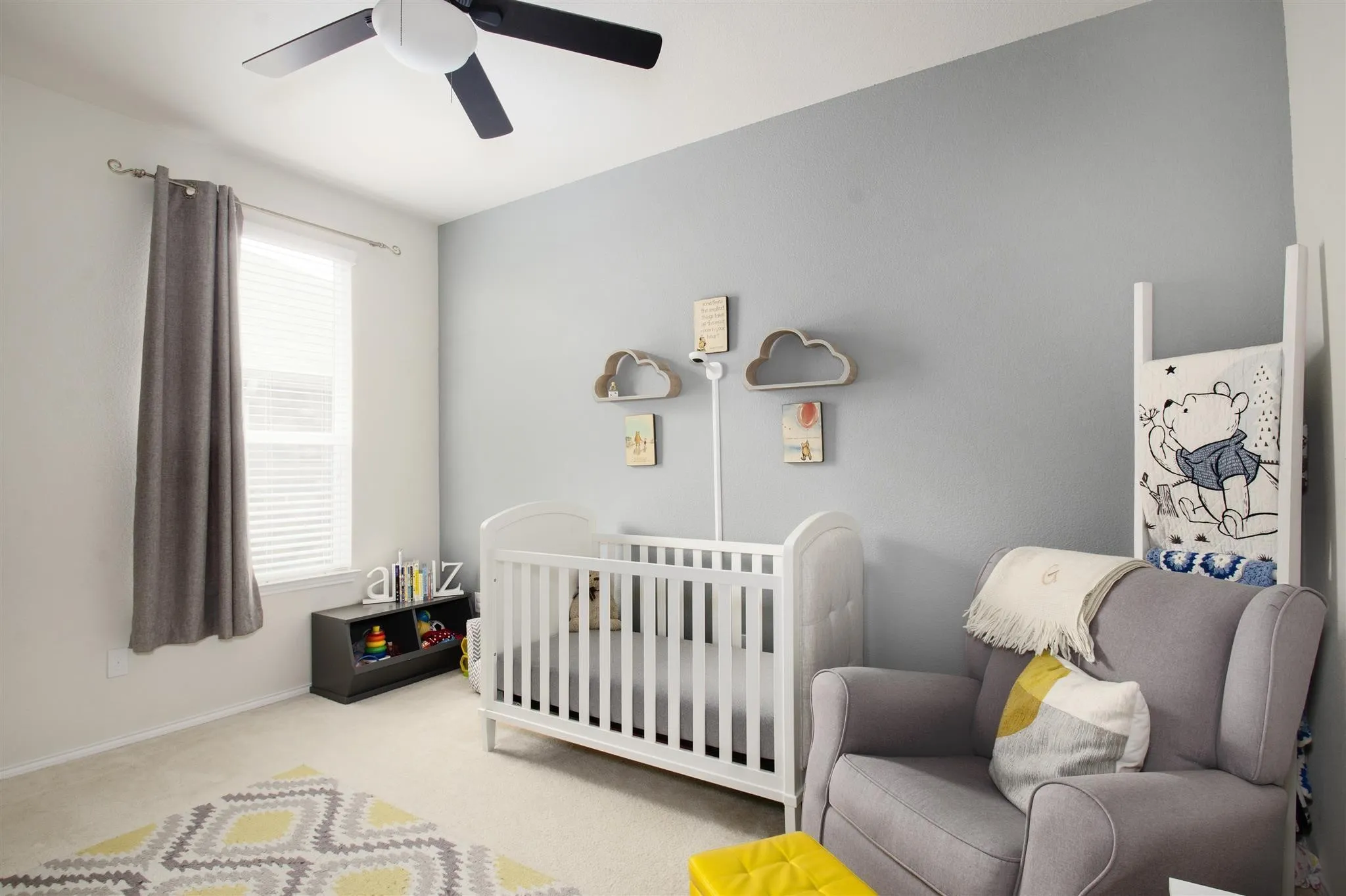 Wall-to-wall carpeting, window with blinds and curtain rod, built-in ceiling fan, and painted walls