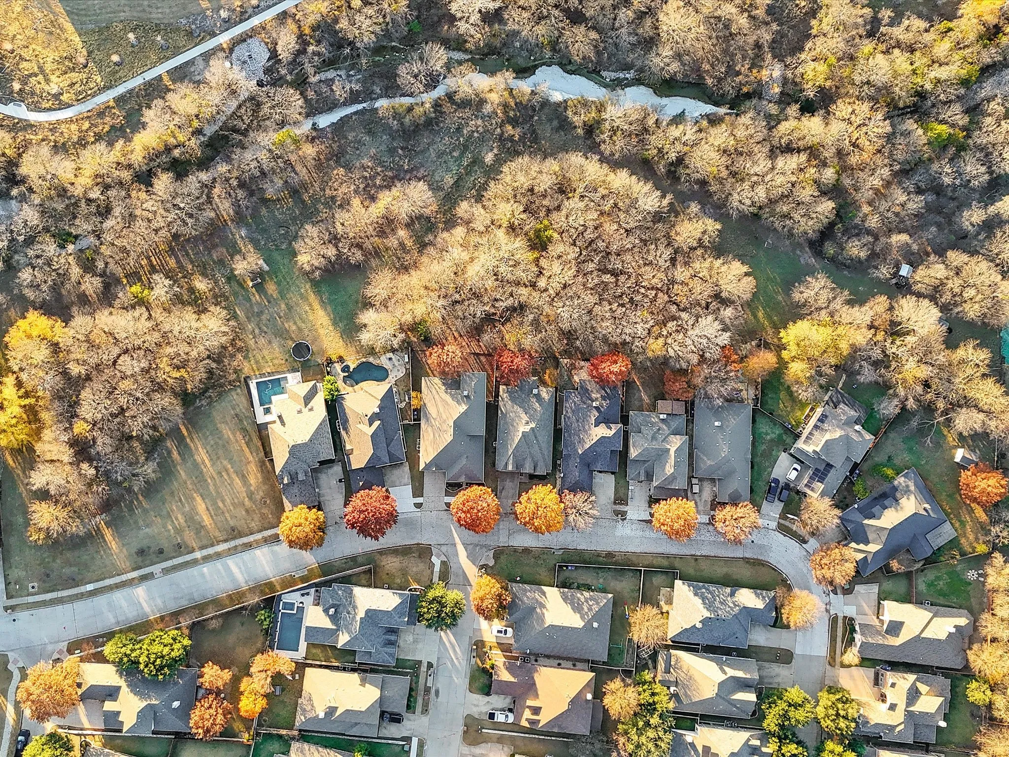 Residential properties featuring pitched roofs and mature landscaping