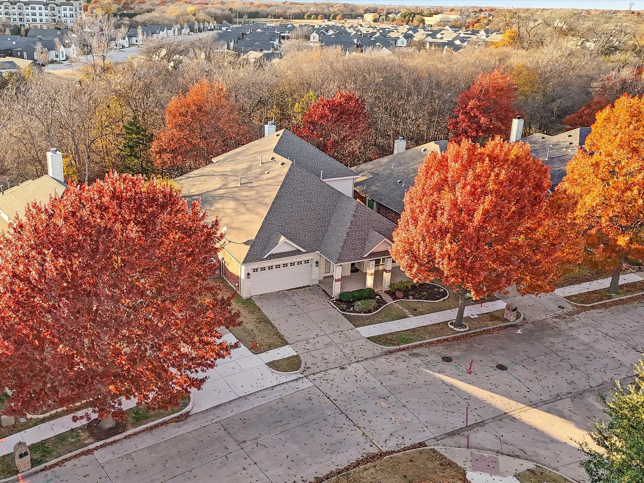 Attached two-car garage, concrete driveway, and covered front entry