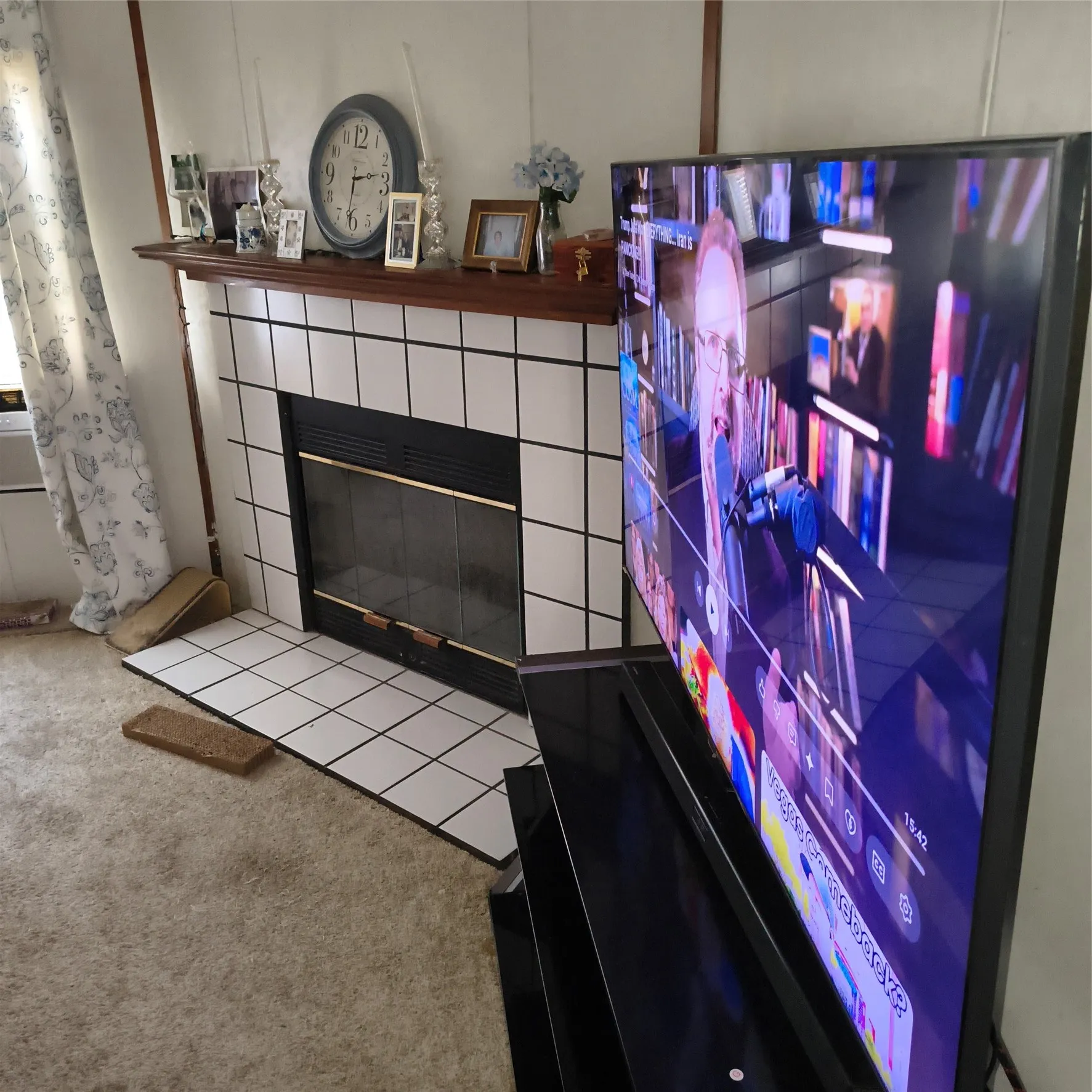 Fireplace with a tile surround and a dark wood mantel