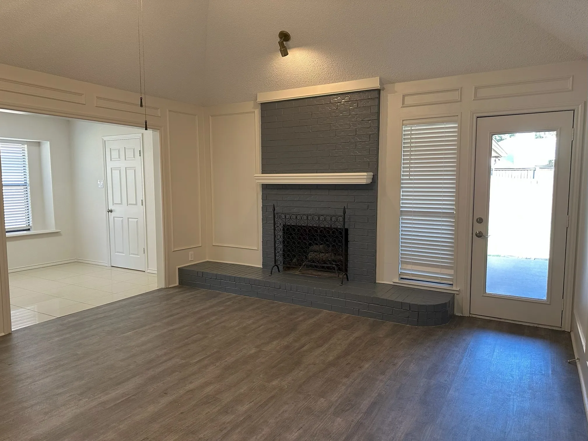 View of kitchen and back door leading to the yard