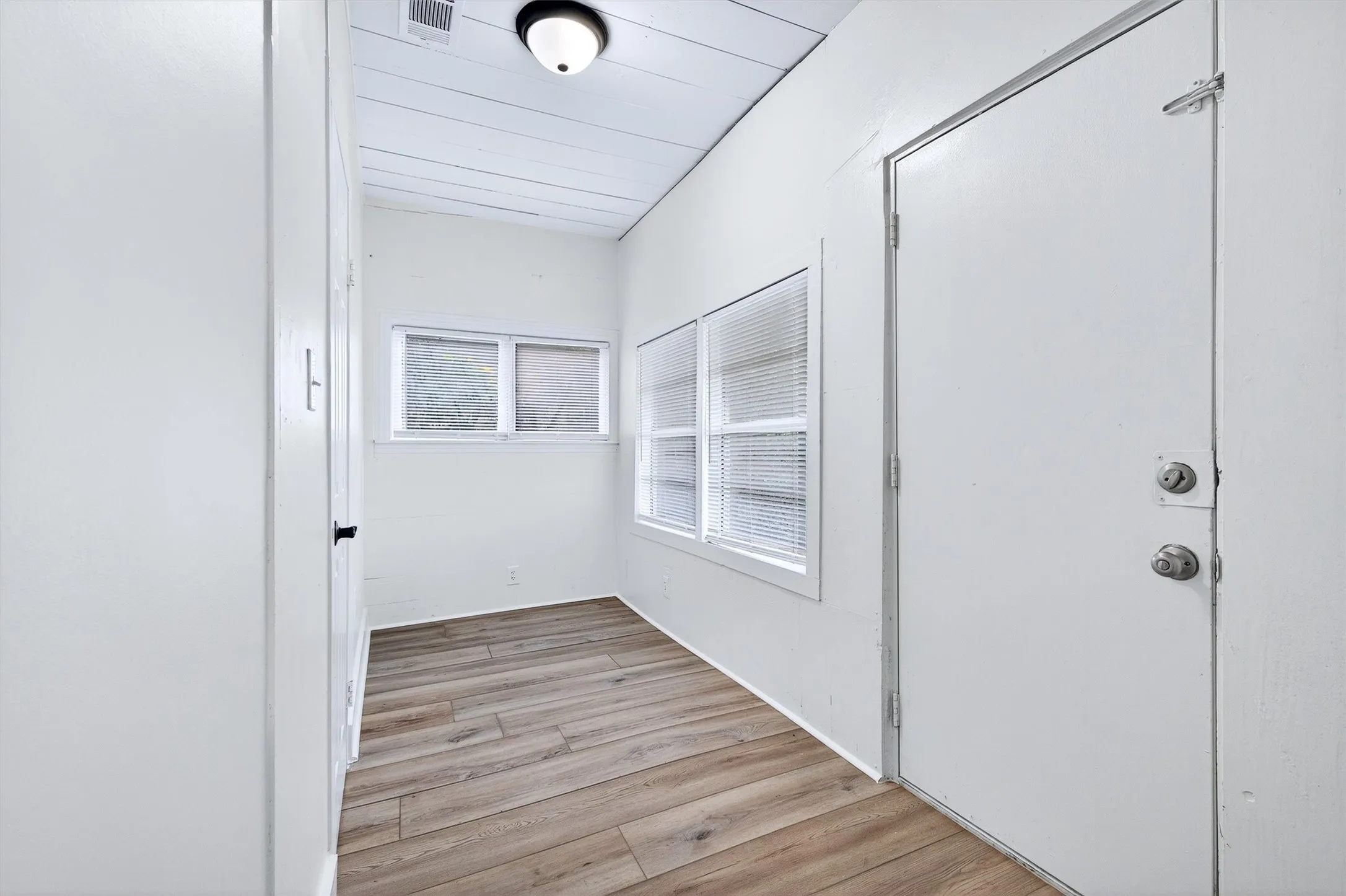 Doorway featuring wood finished floors