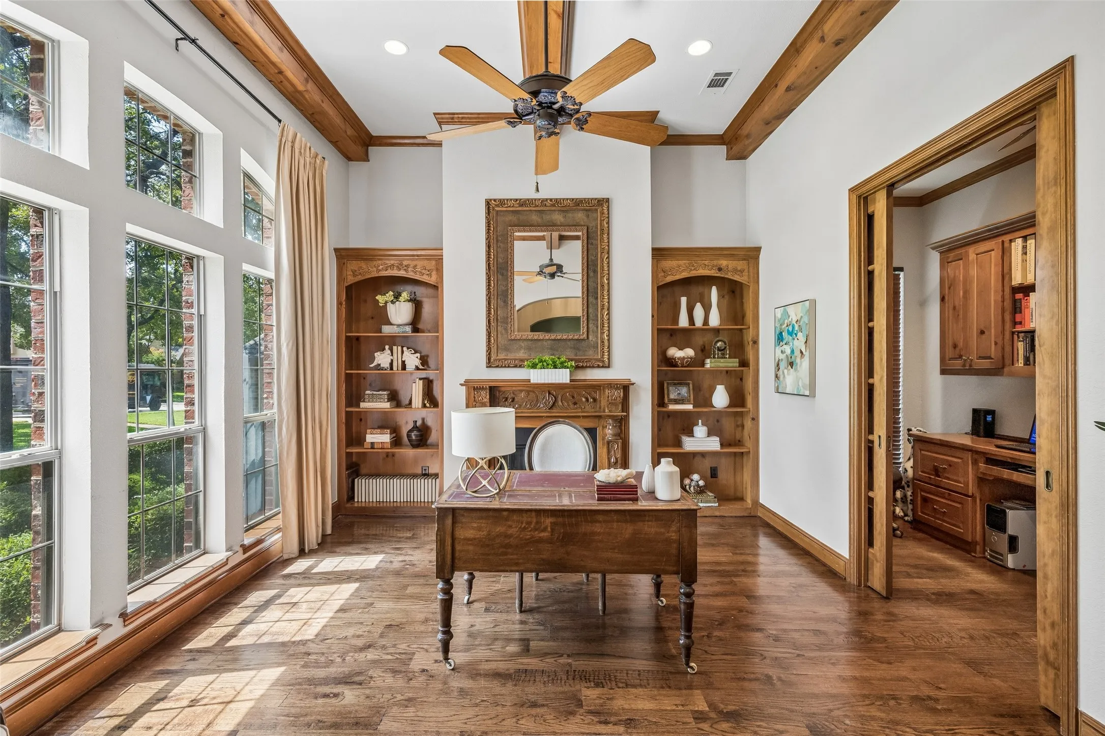 Office with wood beams and adjacent study area
