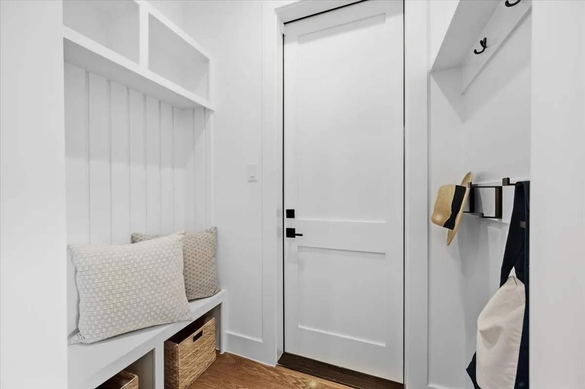 Built-in bench seating with integrated storage, overhead shelving, and wall-mounted coat hooks