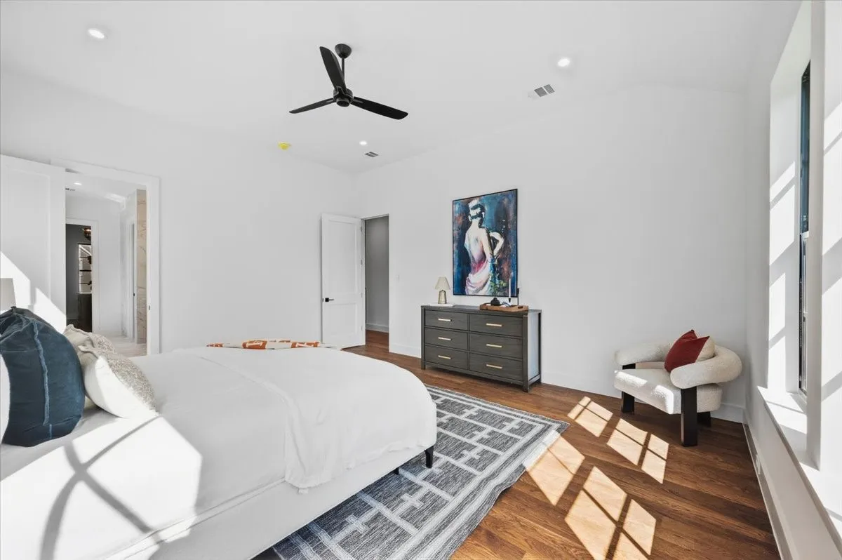 Wood-finish flooring, recessed lighting, and a contemporary ceiling fan