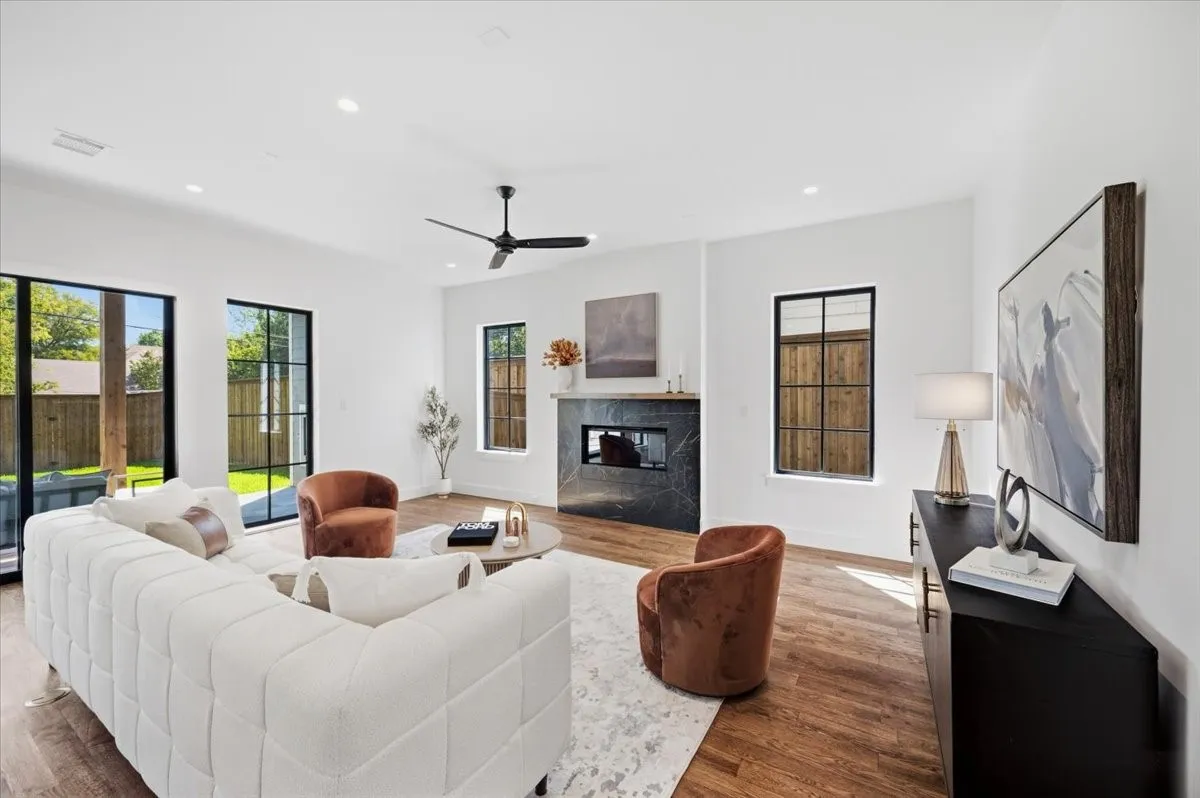 Wood-finish flooring throughout, complemented by a modern ceiling fan and recessed lighting