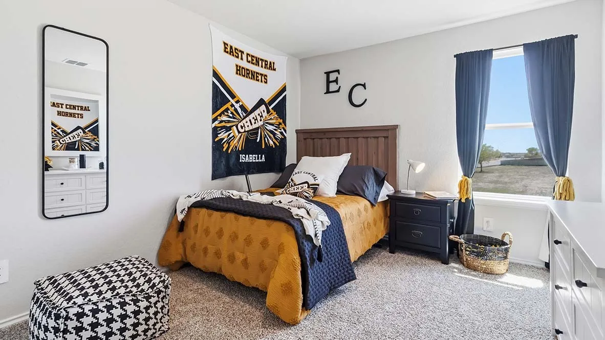 Plush carpeting, paneled wood headboard, and a large window with ample natural light