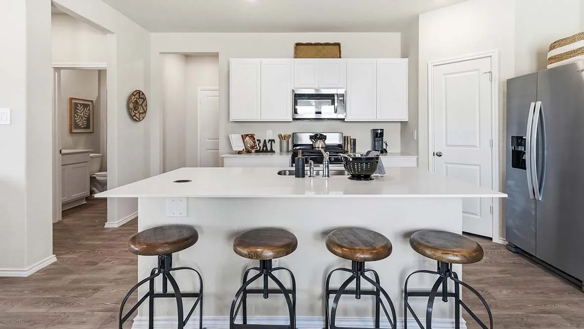 Kitchen featuring a large island, white cabinetry, stainless steel appliances, and wood-finish flooring