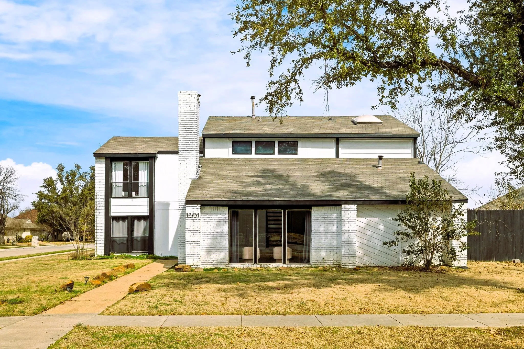 White brick facade with dark trim accents