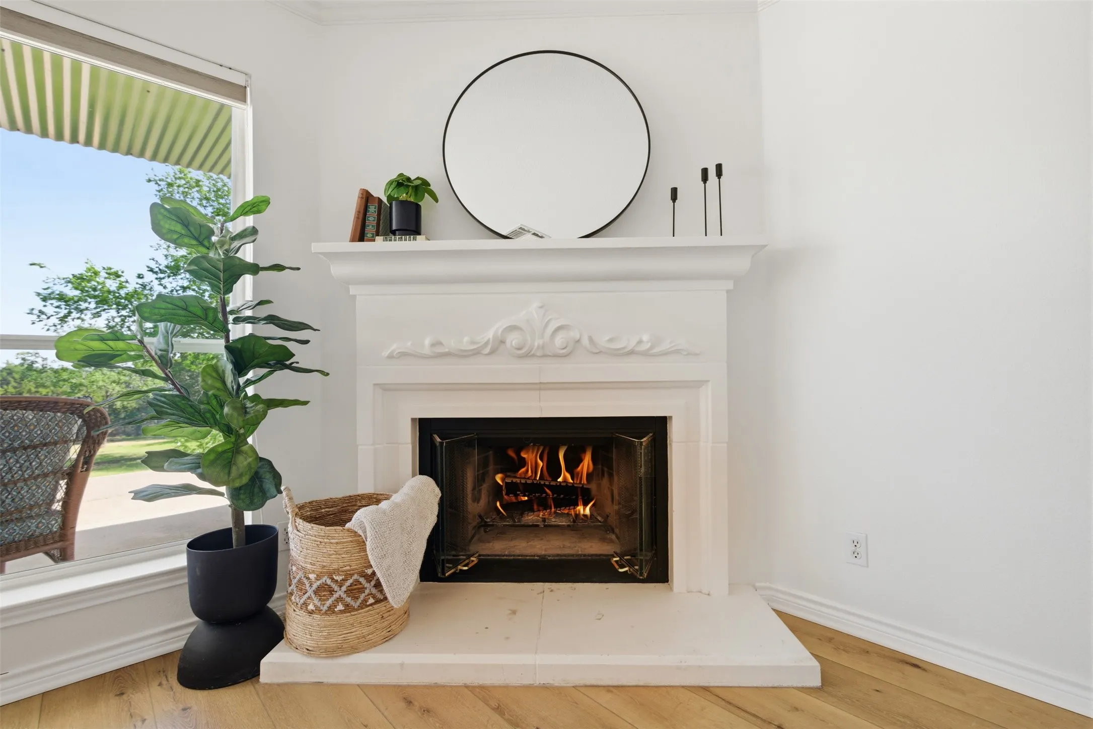 White fireplace with ornate mantel, fireplace surround, and hearth