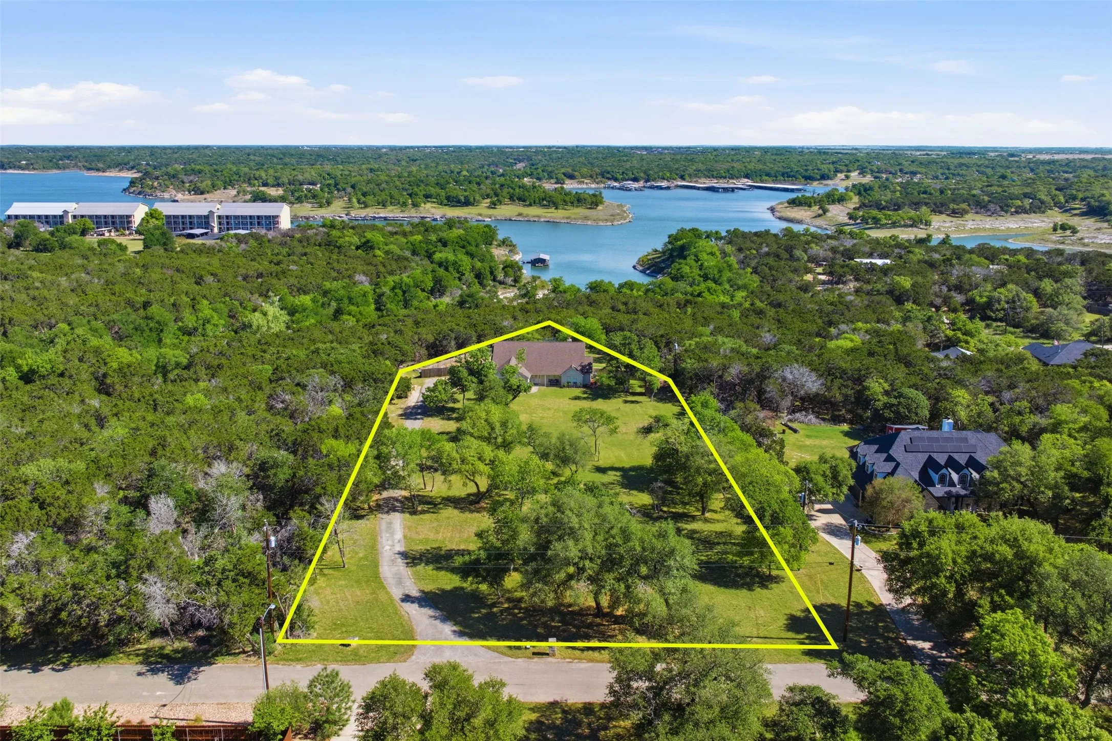 Expansive property with mature trees, a private driveway, and a natural landscape