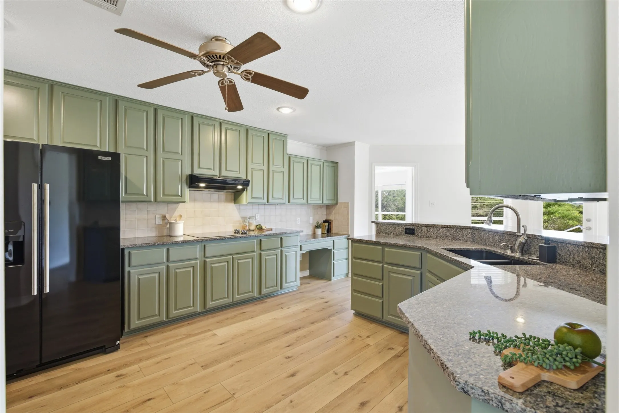 Kitchen featuring light green cabinetry, wood-finish flooring, recessed lighting, a ceiling fan, and stone countertops
