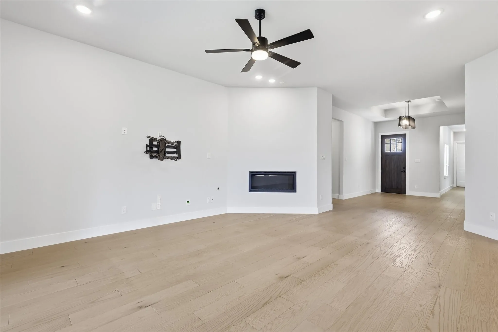 Recessed lighting, wood-finish flooring, and a built-in fireplace