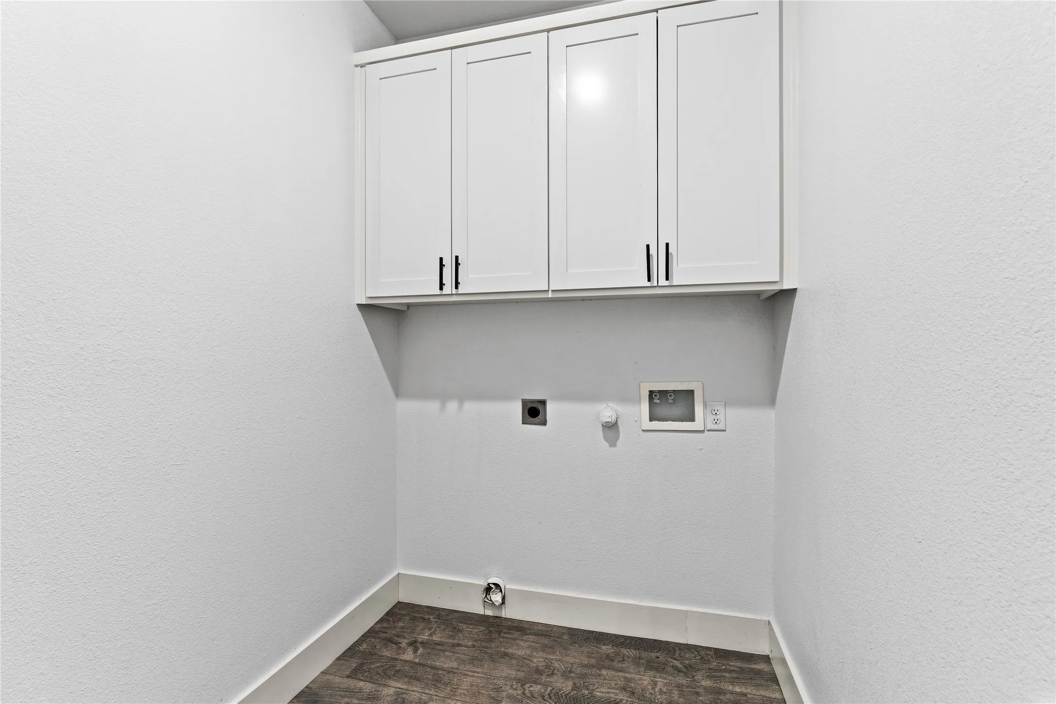White shaker-style cabinetry with matte black hardware