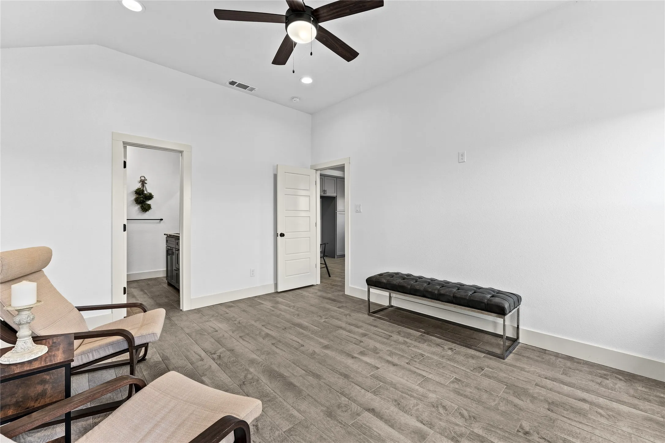 Vaulted ceiling with recessed lighting and a ceiling fan