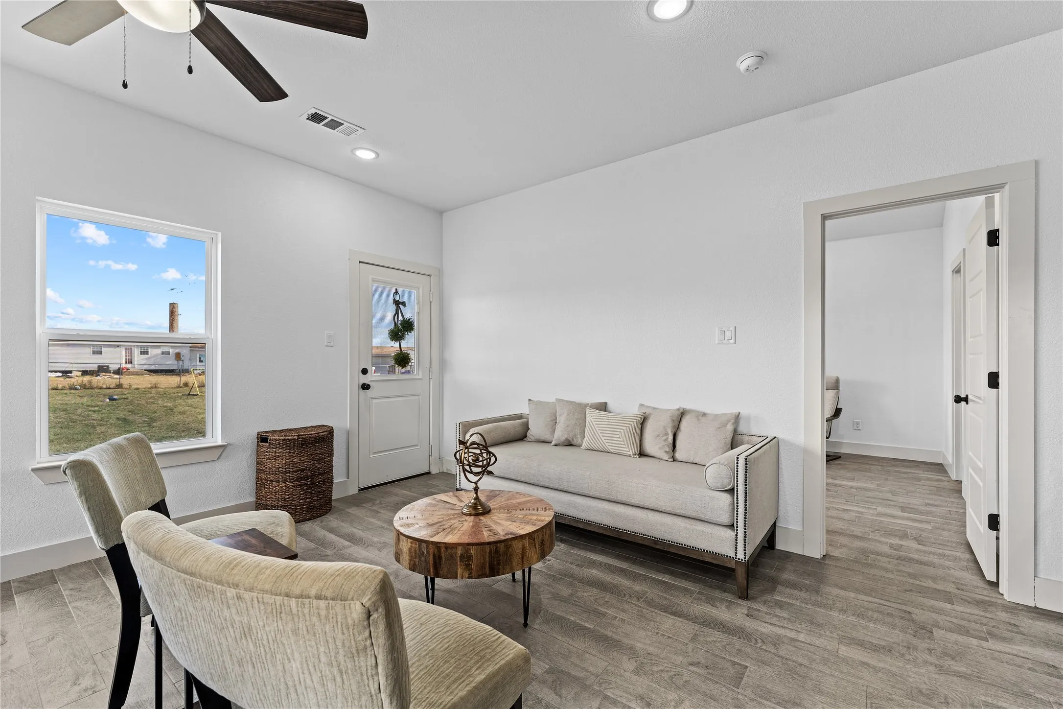 Recessed lighting, ceiling fan with light fixture, wood-finish flooring, white trim, and a glass-paneled entry door